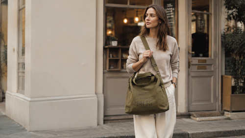 Olive canvas shoulder bag on an everyday errand